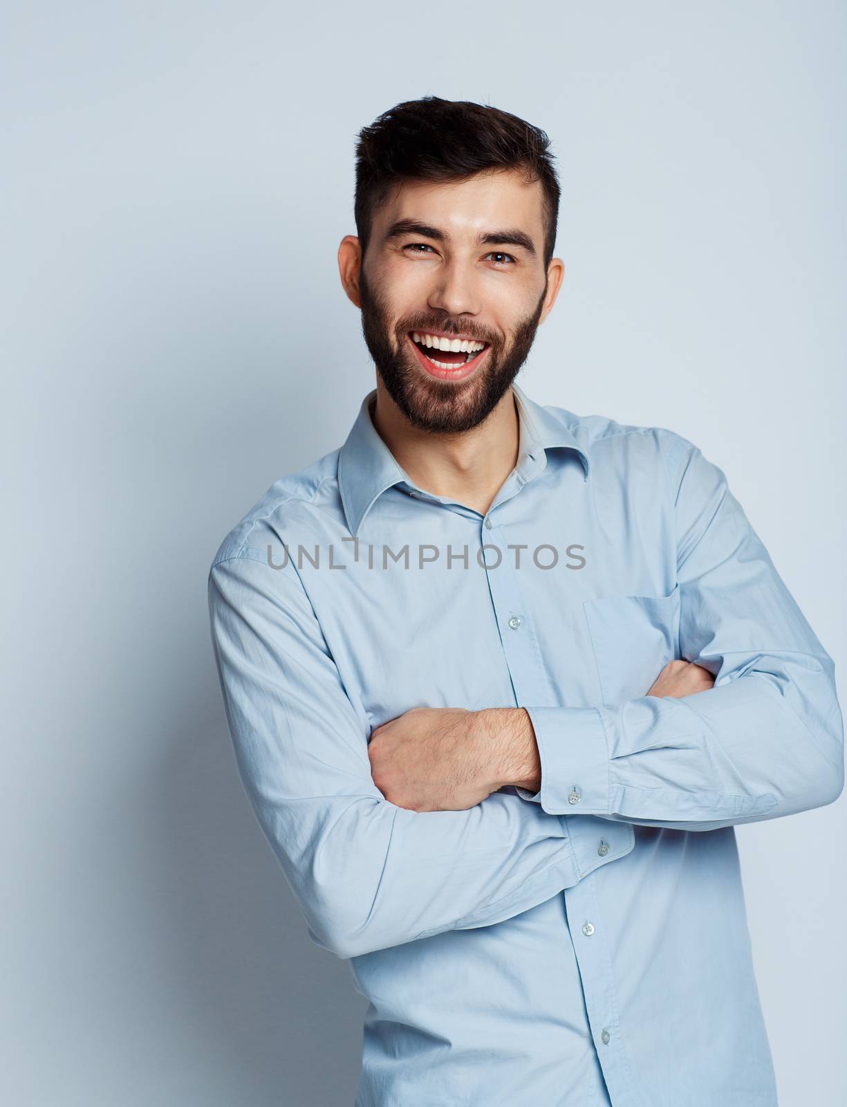 A young bearded man smiling