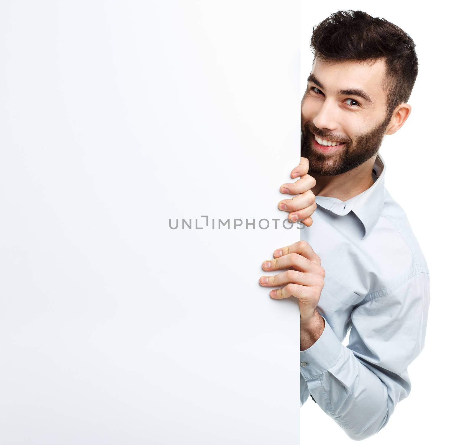 A young bearded man showing blank signboard, isolated over white background