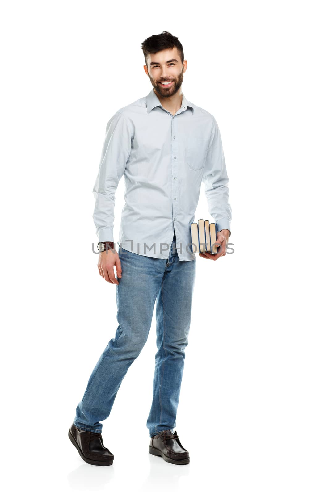 Young bearded smiling man with books in hand on white by vlad_star