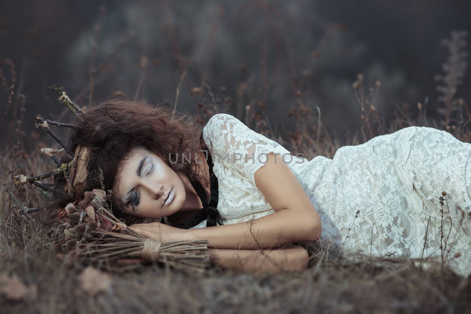 Young girl in the image of a bride lying on the ground by vlad_star