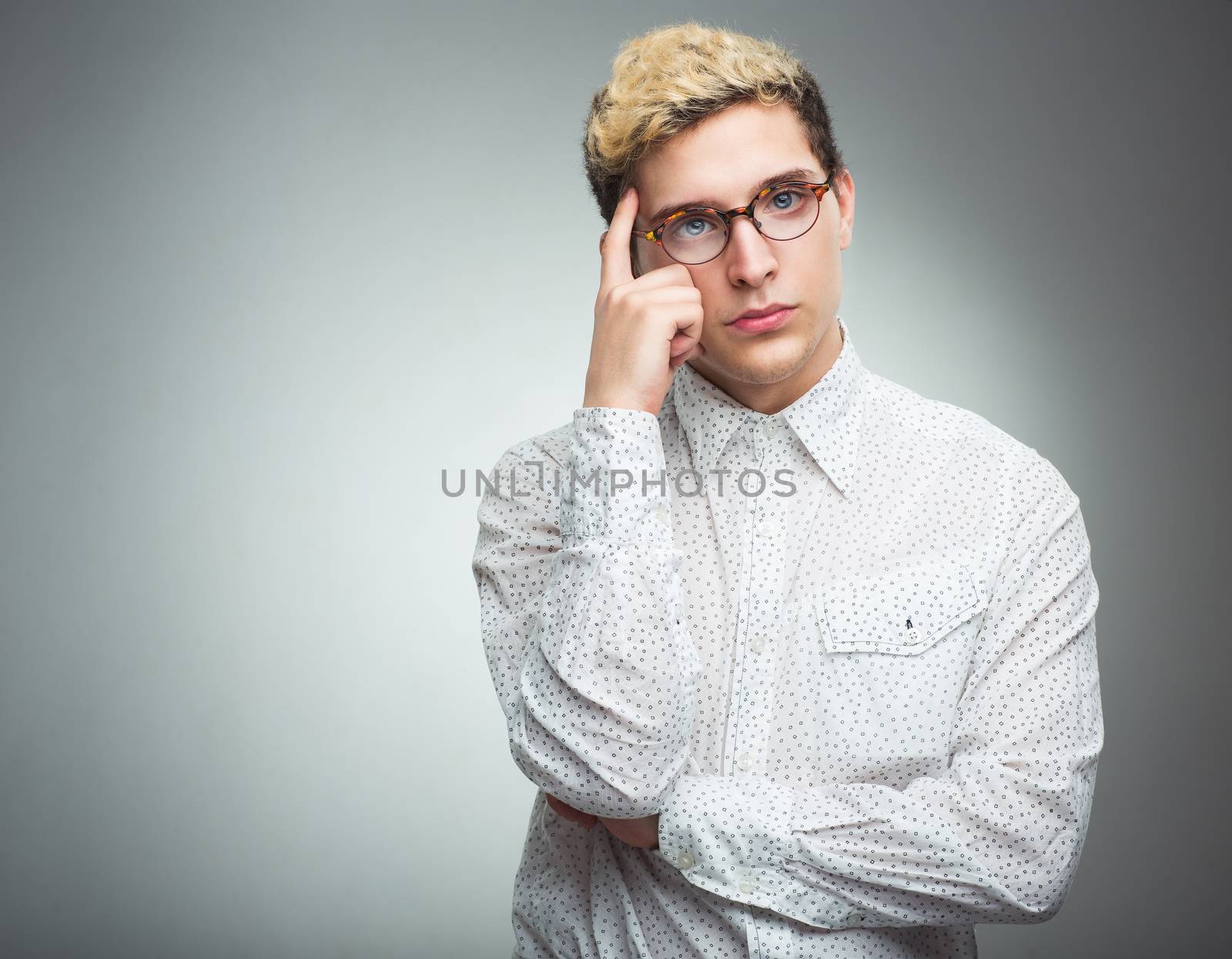 Young man with glasses thinking by vlad_star