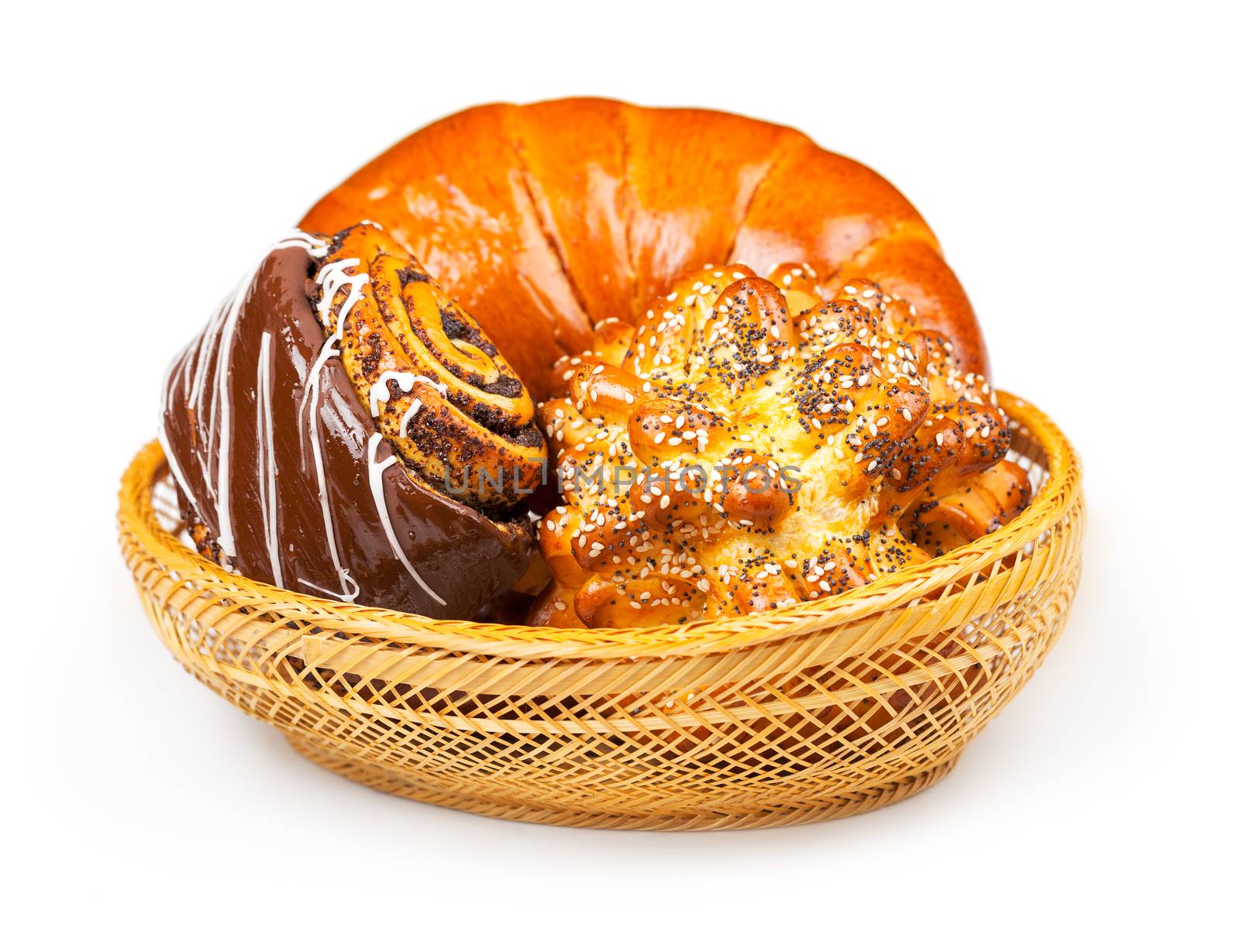 Fresh and tasty buns with with sesame and poppy seeds, bagel with jam and roll with chocolate in a basket over white background