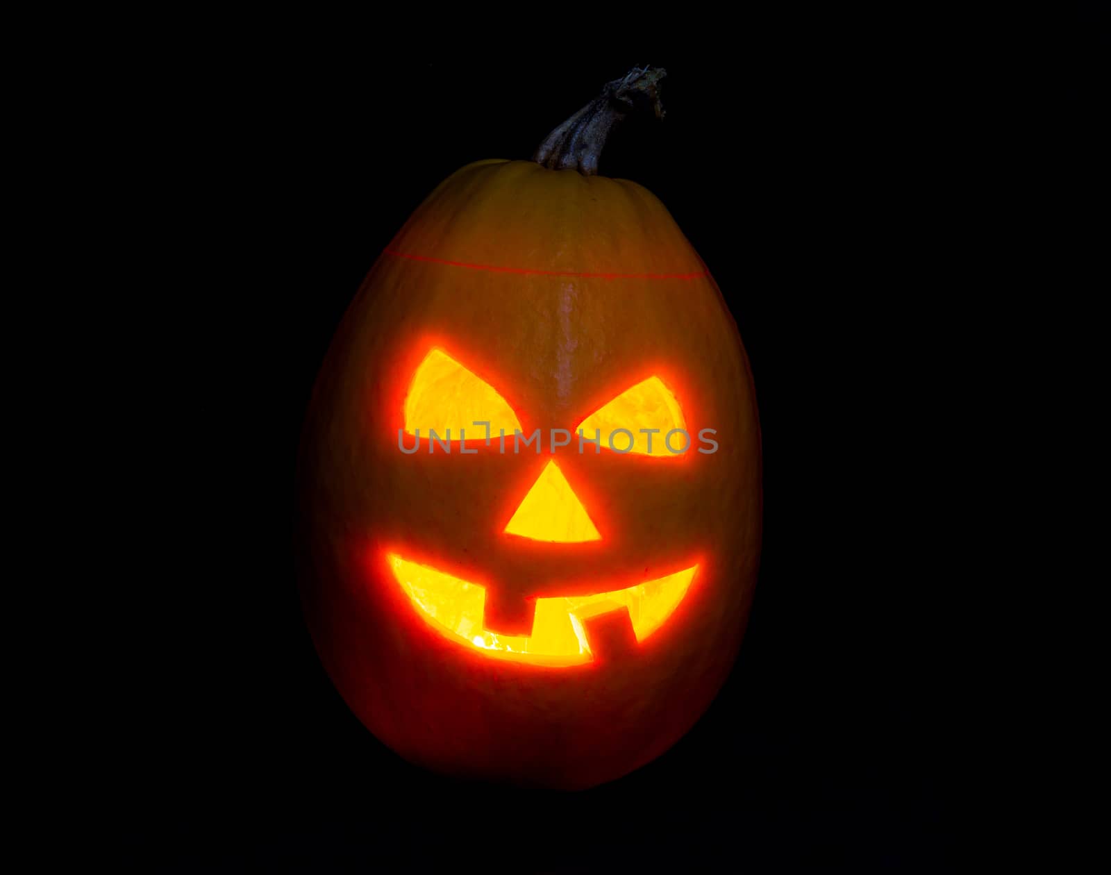 Halloween pumpkin jack-o-lantern candle lit, isolated on black by vlad_star