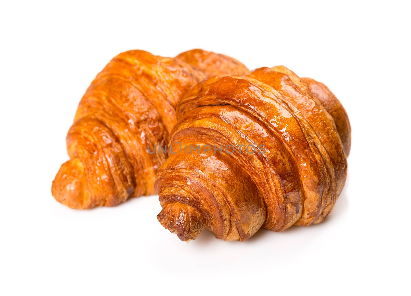 Fresh and tasty croissant over white background