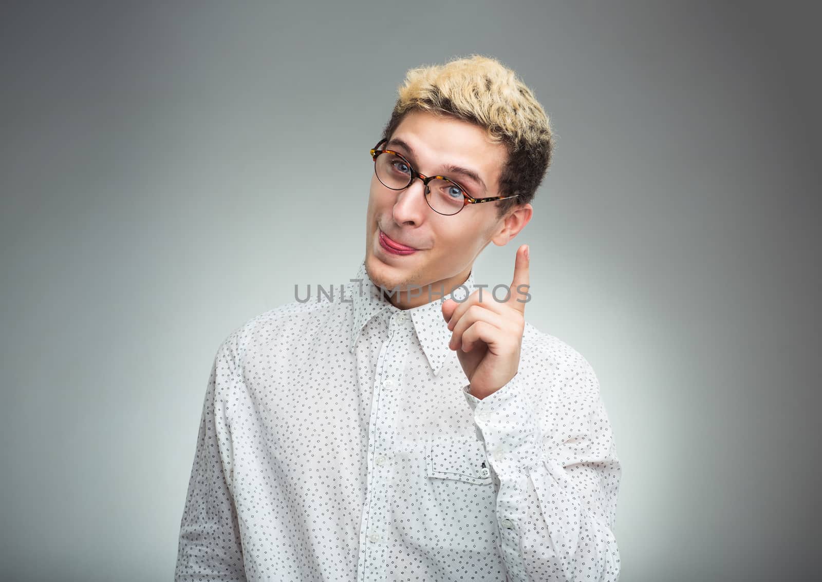 Young man in glasses with a funny expression on his face and thu by vlad_star