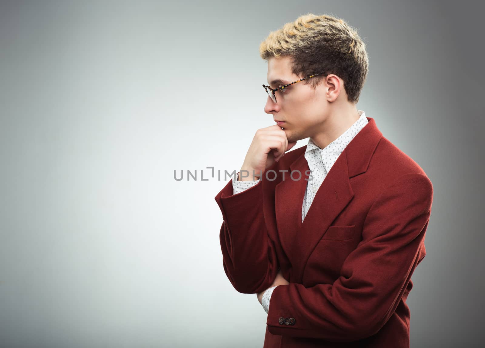 Young man with glasses thinking by vlad_star