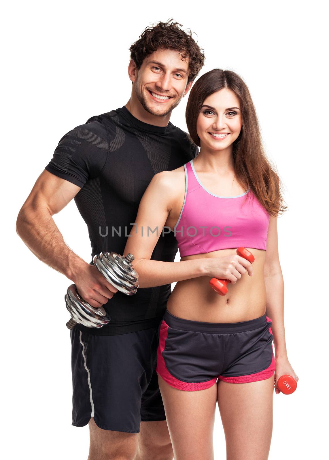 Athletic couple - man and woman with dumbbells on the white background