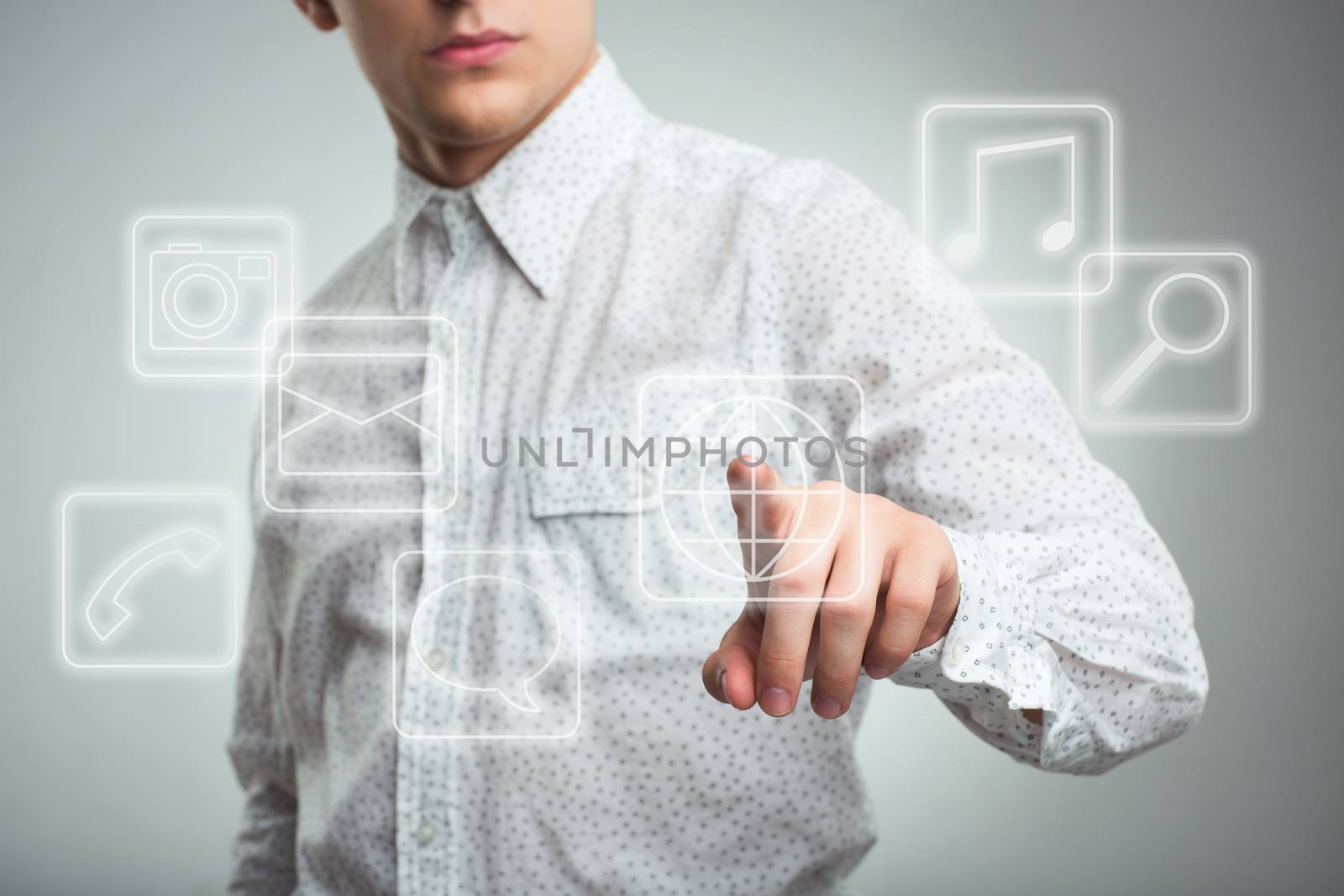 Young businessman pressing application button on computer with touch screen