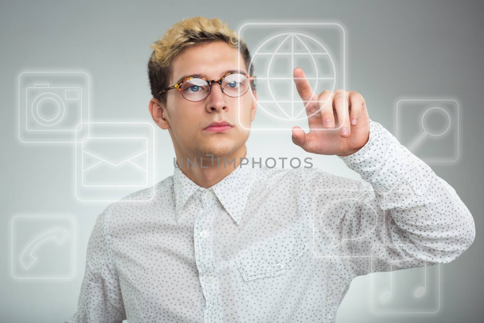 Young businessman pressing application button on computer with touch screen