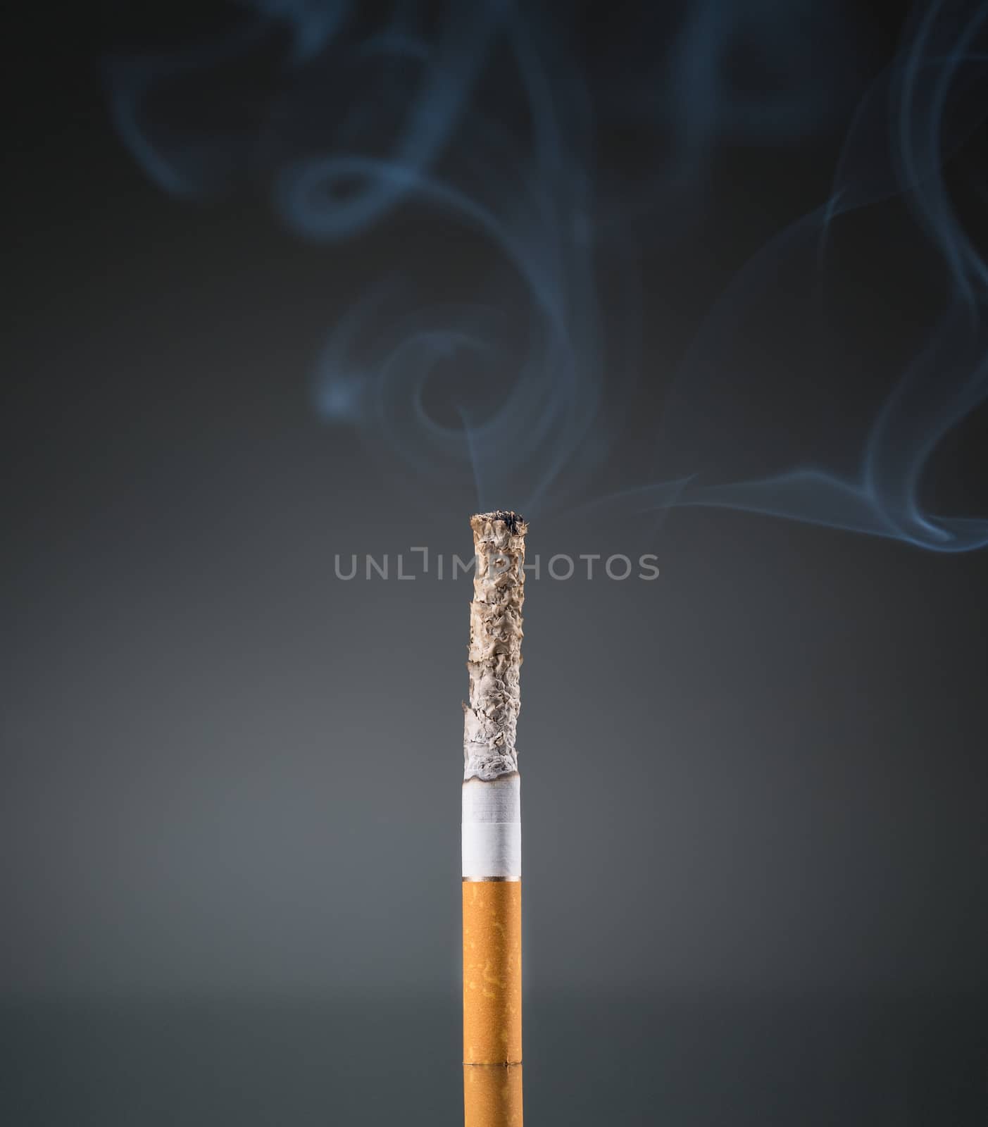 Smoking cigarette on black background