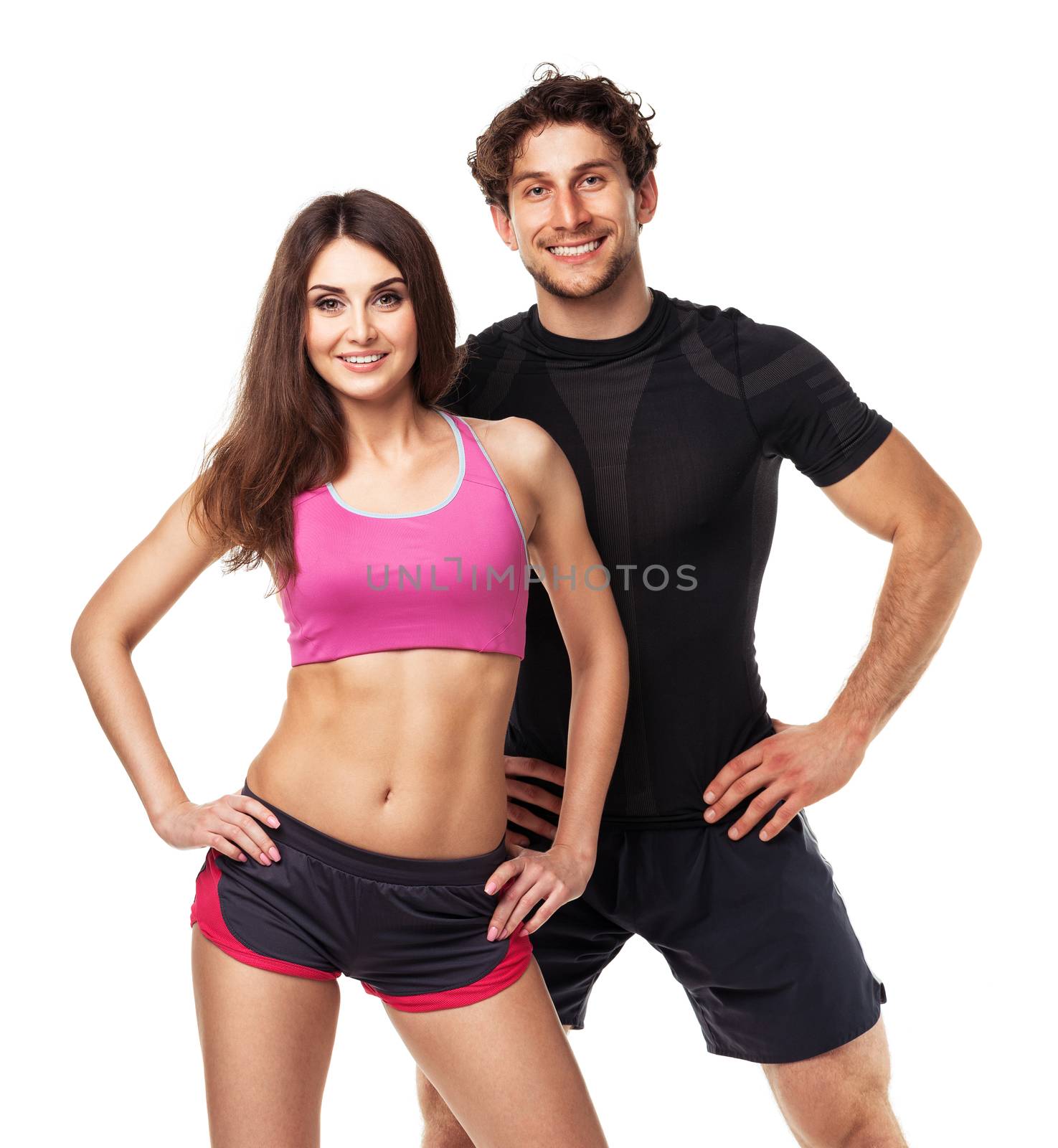 Athletic couple - man and woman after fitness exercise on the white background