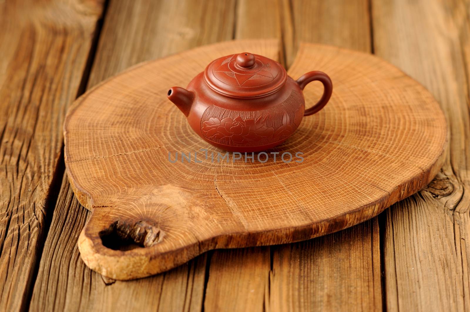 Small yixing red clay teapot on wooden board horizontal