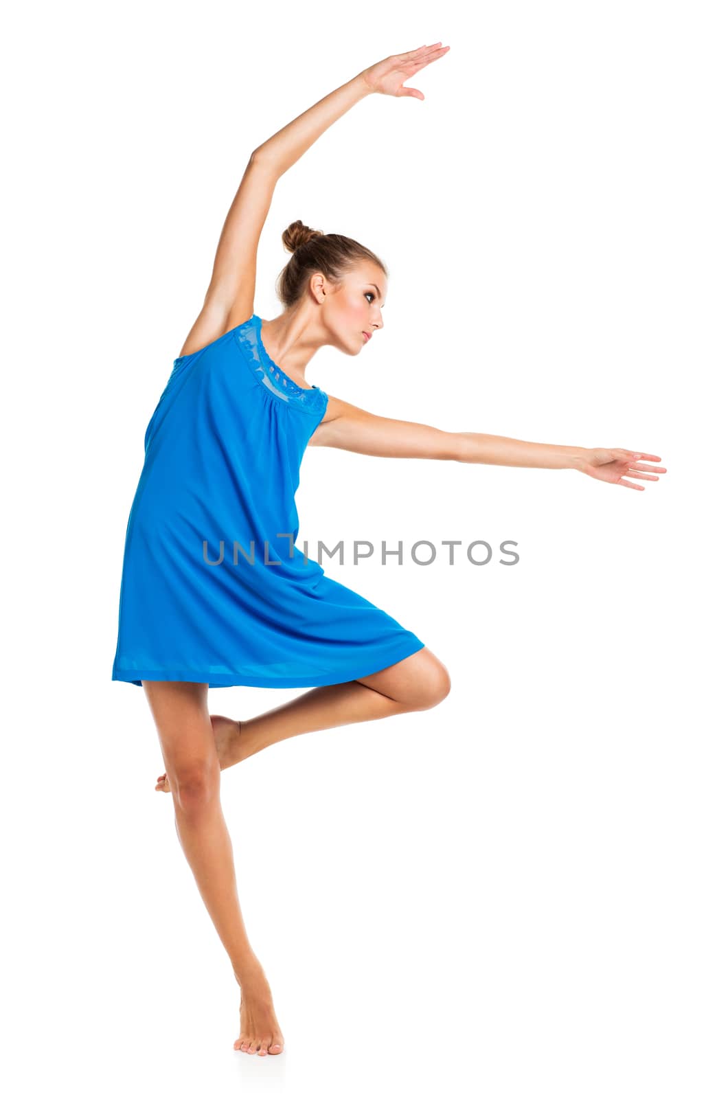 Young girl dancing in a blue dress on a white background