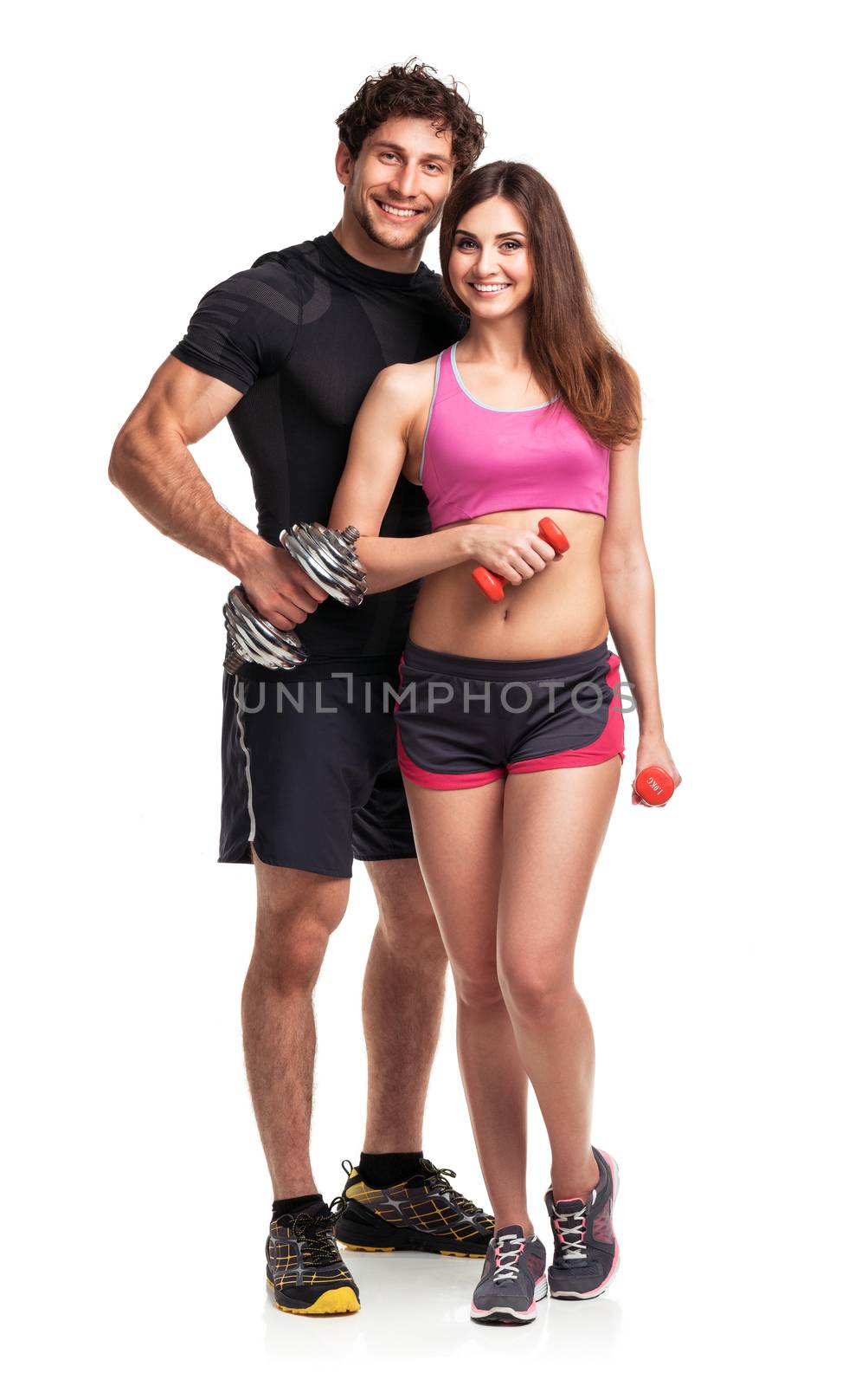 Athletic couple - man and woman with dumbbells on the white background