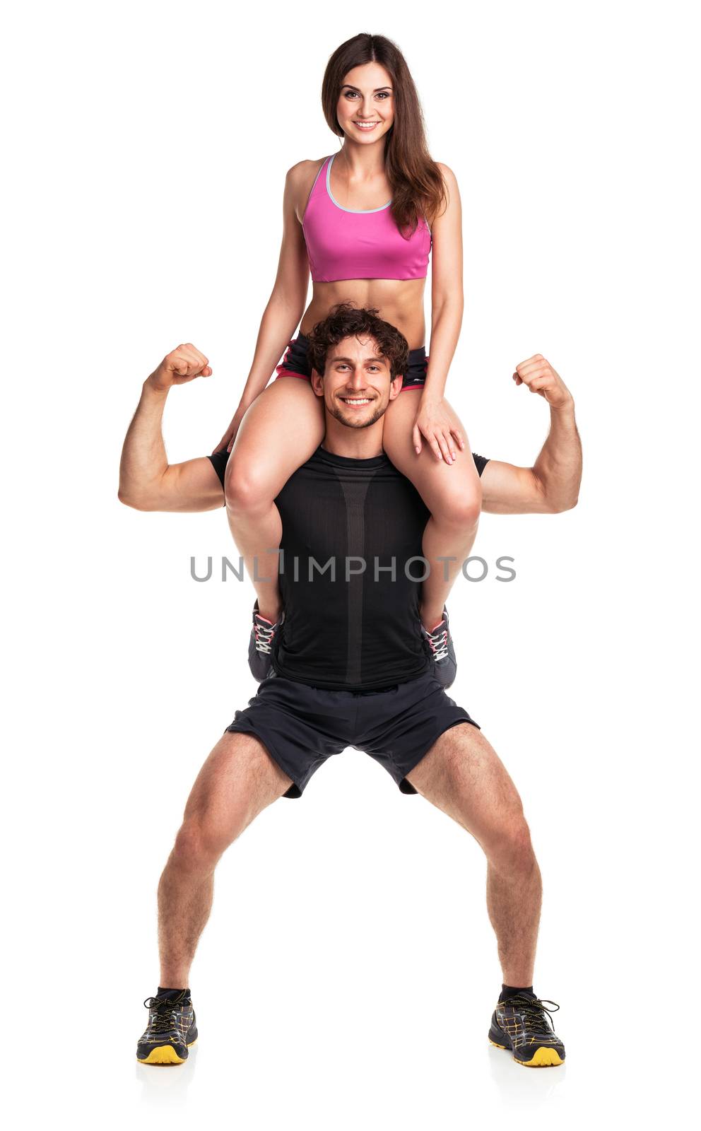 Sports guy holds on shoulder a girl on a white background