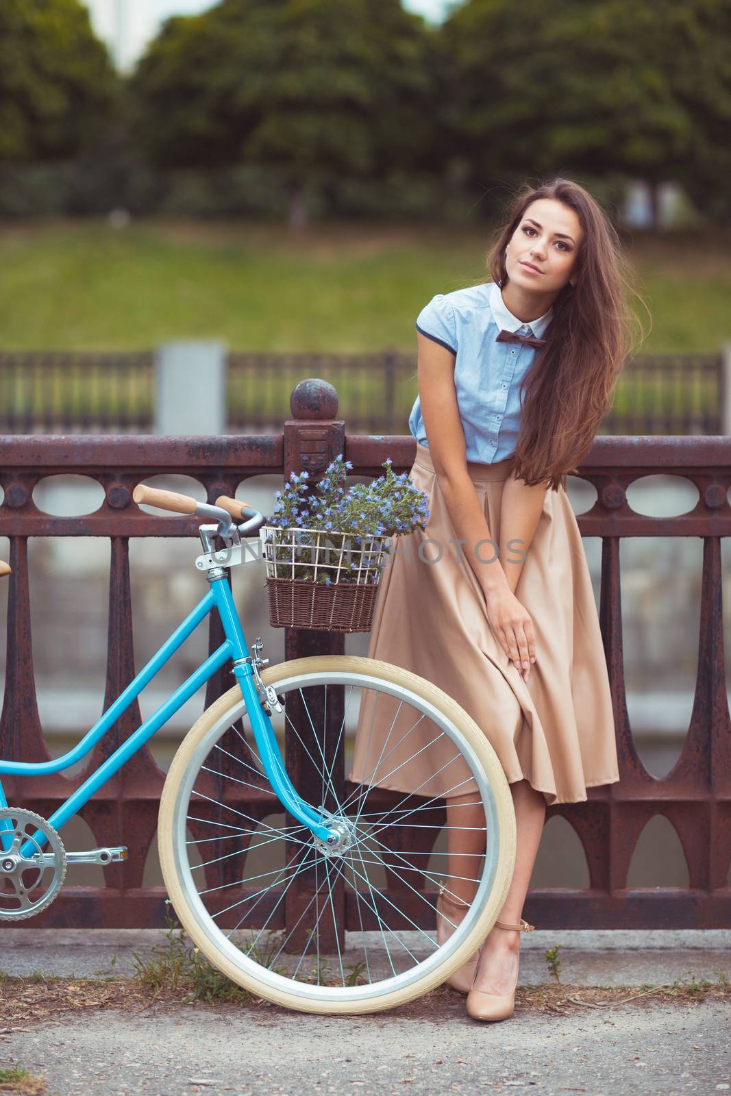 Young beautiful, elegantly dressed woman with bicycle, summer and lifestyle