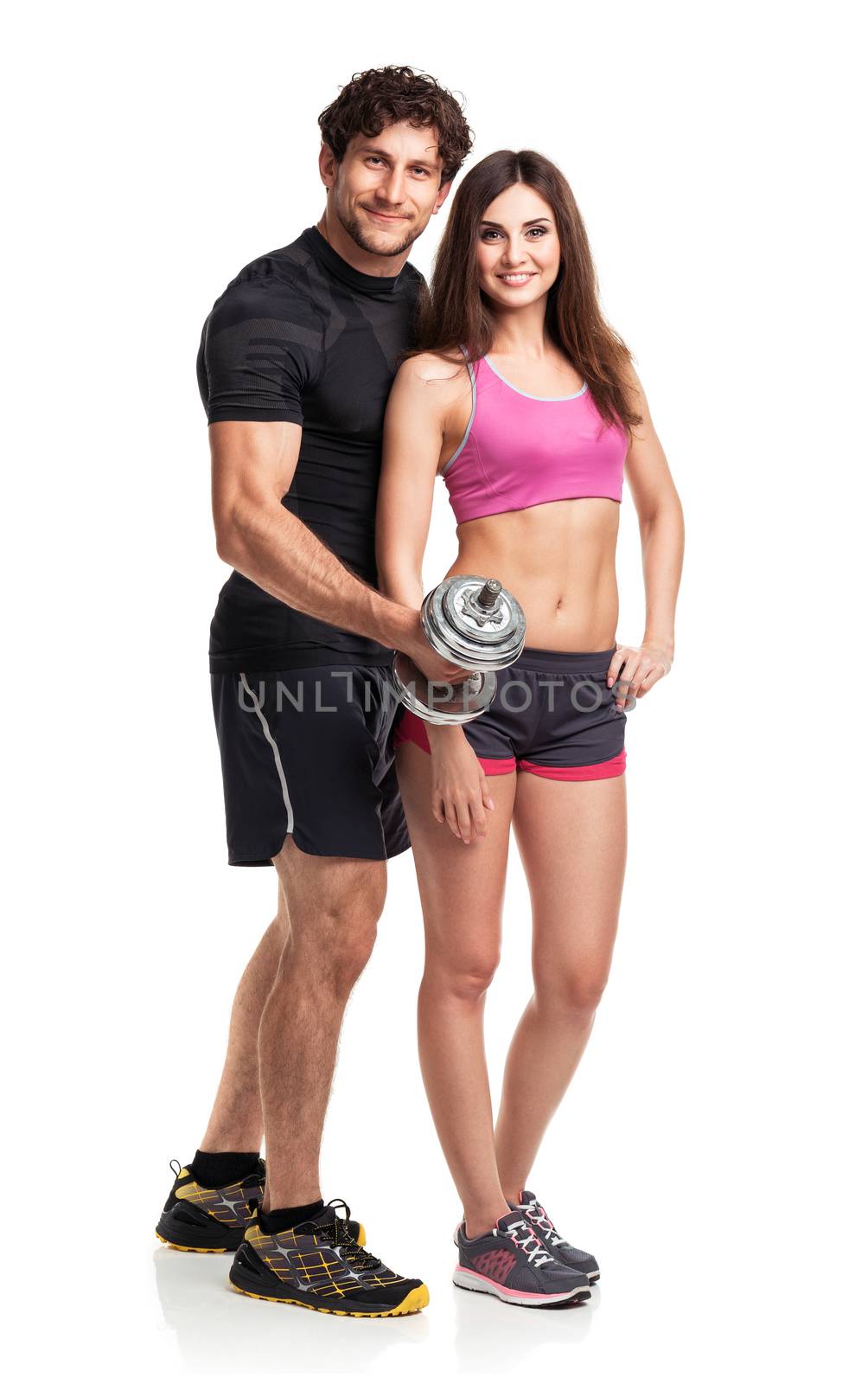 Athletic couple - man and woman with dumbbells on the white background