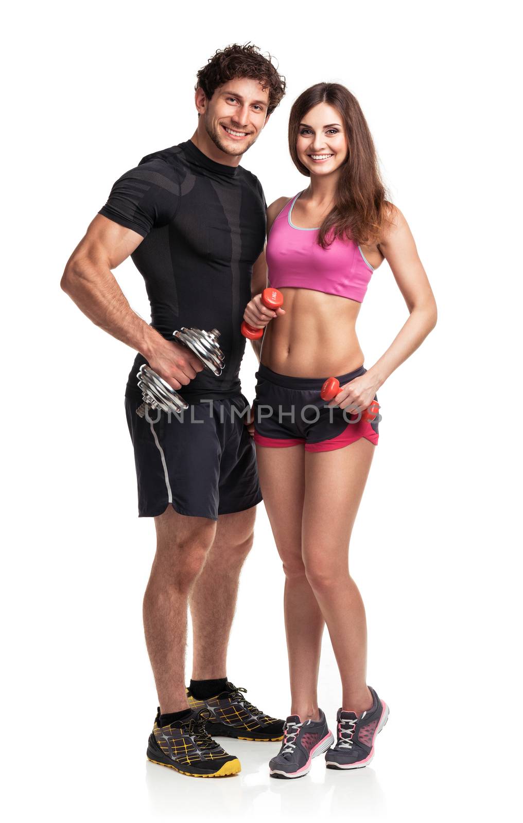 Athletic couple - man and woman with dumbbells on the white background