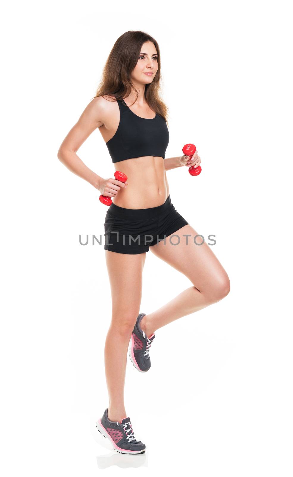 Beautiful slim woman with dumbbells isolated on white background