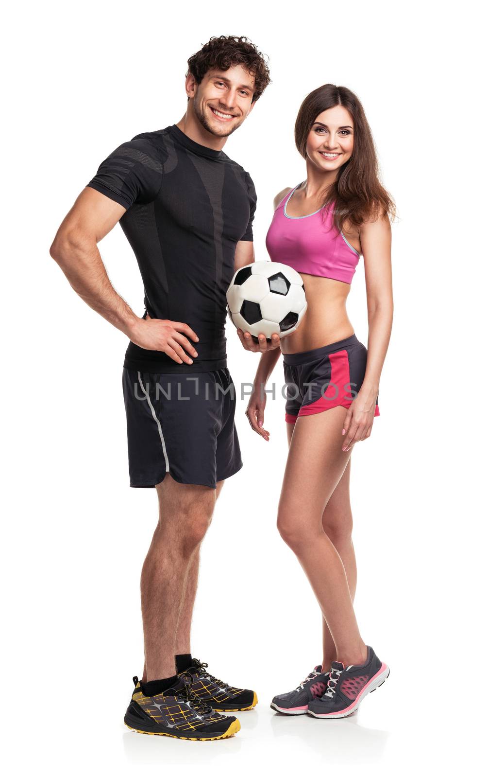 Athletic couple - man and woman with ball on the white background