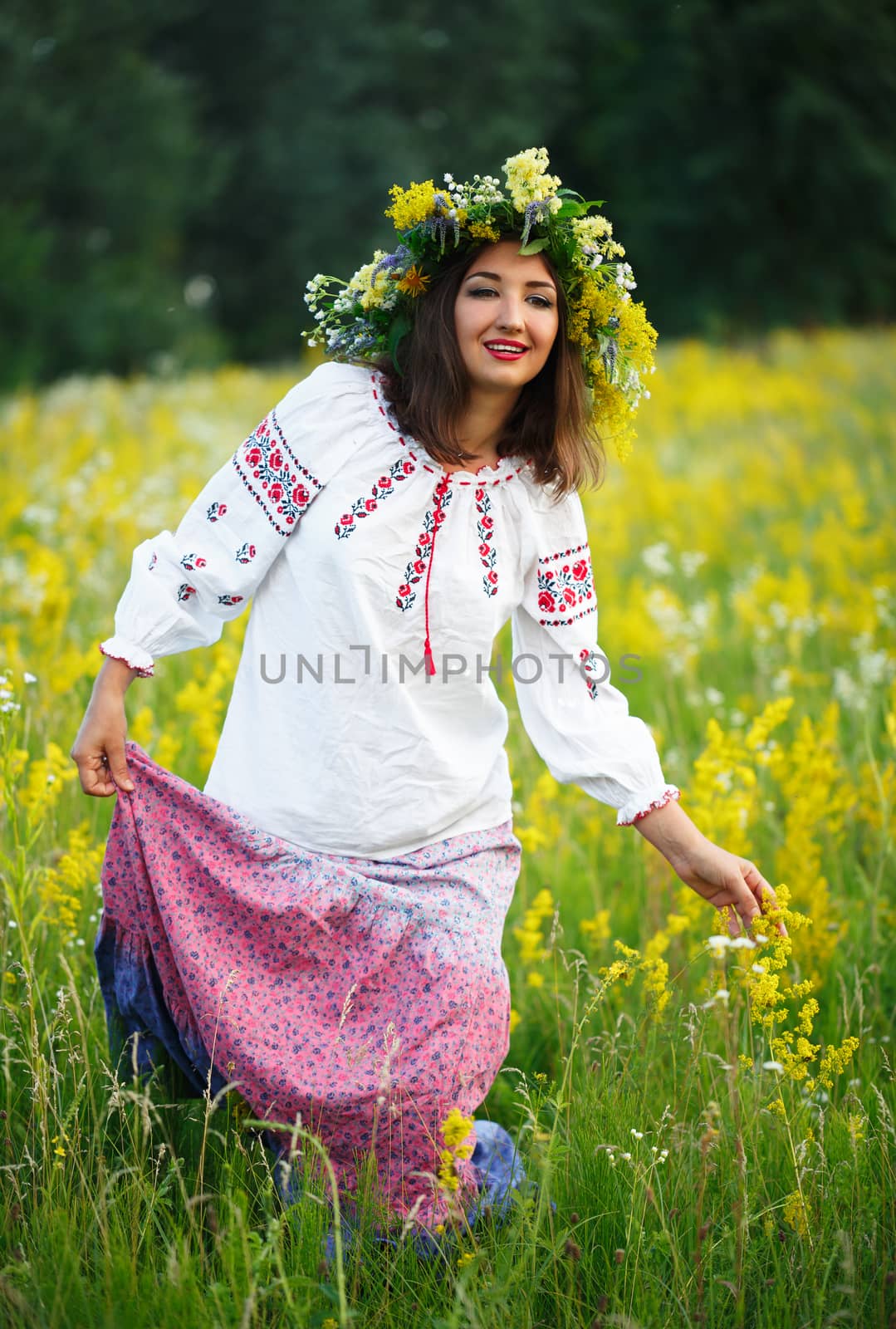 Young smiling girl in Ukrainian costume with a wreath on his hea by vlad_star