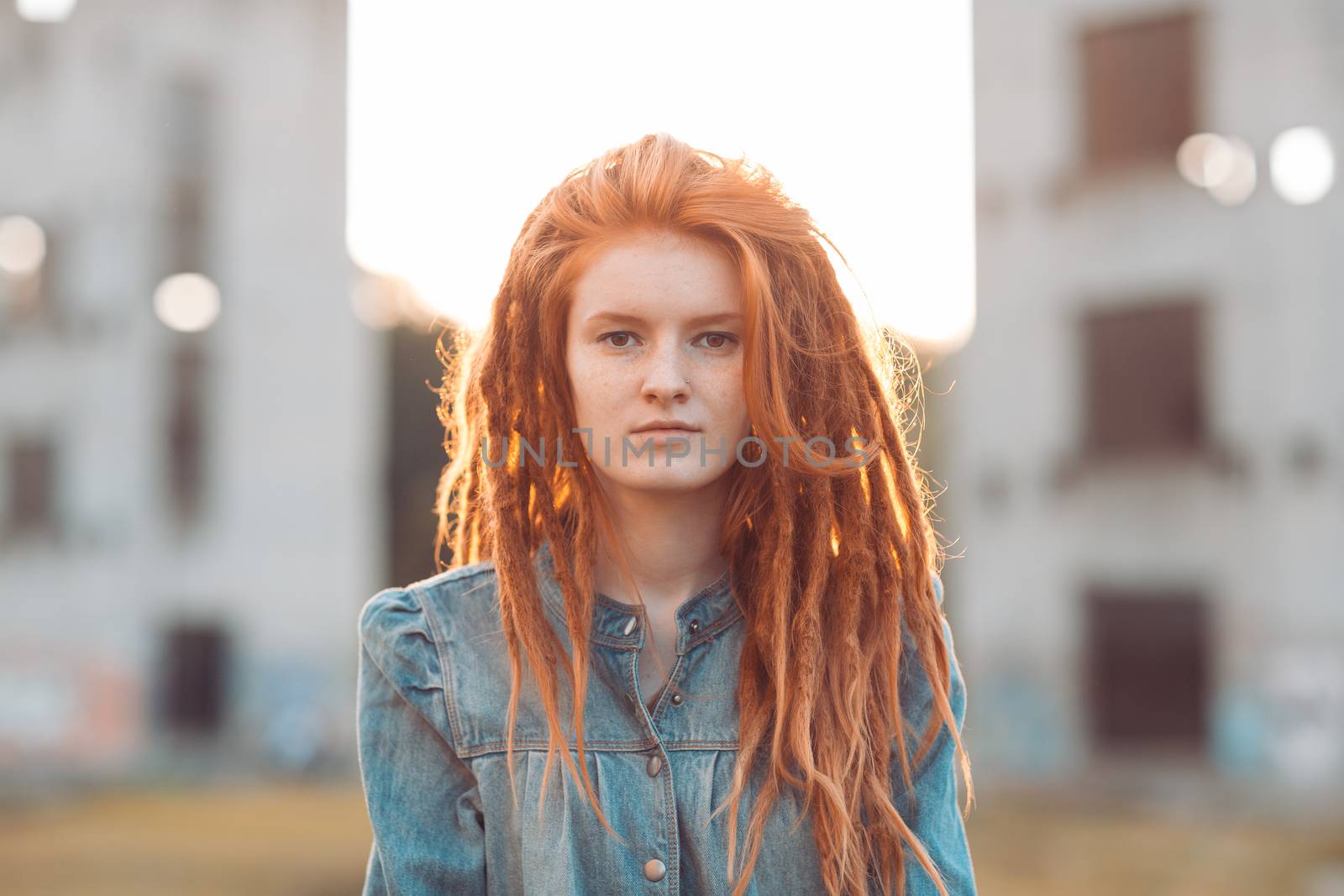 Young stylish girl with dreadlocks outdoors