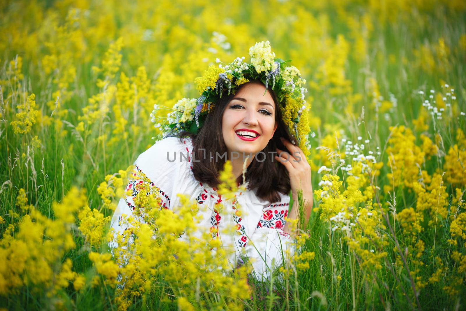 Young smiling girl in Ukrainian costume with a wreath on his hea by vlad_star