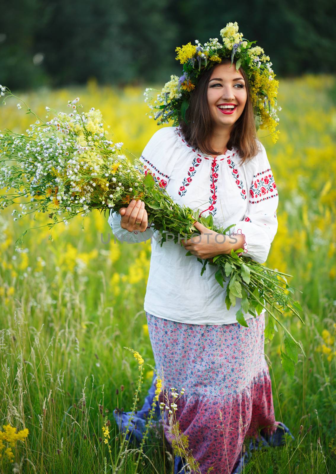 Smiling girl in Ukrainian costume with a wreath on his head in a by vlad_star