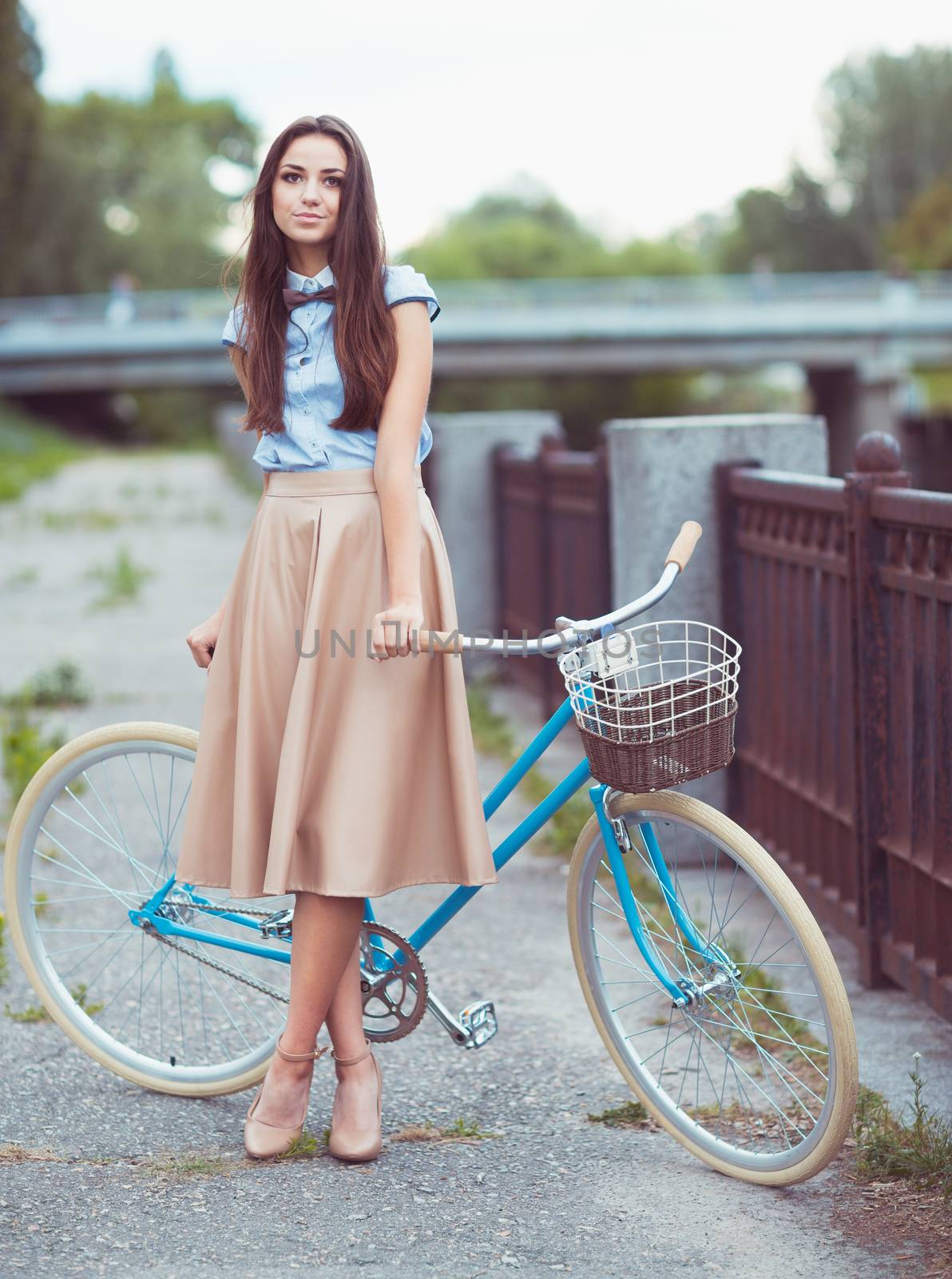 Young beautiful, elegantly dressed woman with bicycle by vlad_star