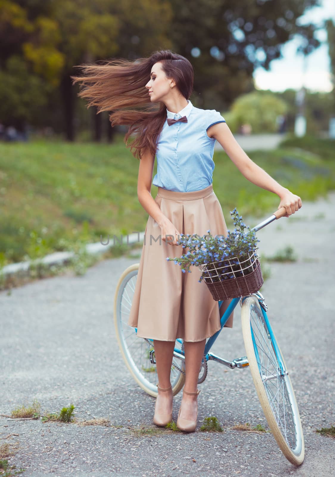 Young beautiful, elegantly dressed woman with bicycle, summer and lifestyle