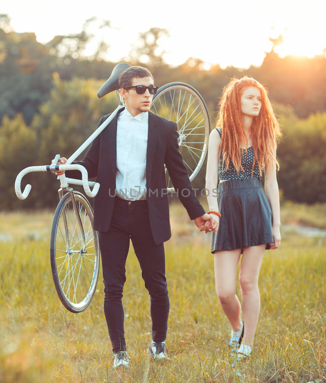Guy with the girl and bicycle outdoors by vlad_star