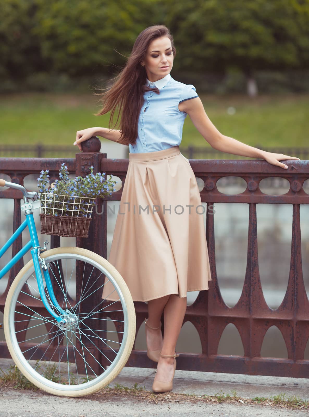 Young beautiful, elegantly dressed woman with bicycle by vlad_star