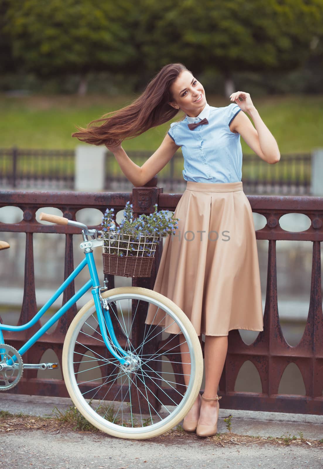 Young beautiful, elegantly dressed woman with bicycle, summer and lifestyle