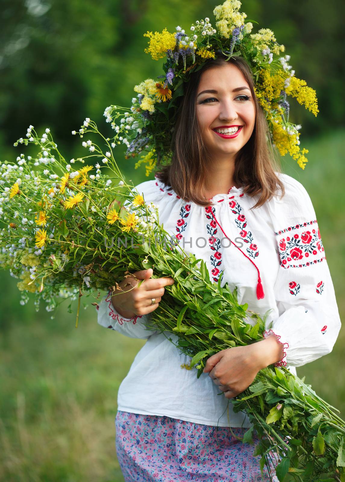 Young beautiful smiling girl in Ukrainian costume with a wreath  by vlad_star