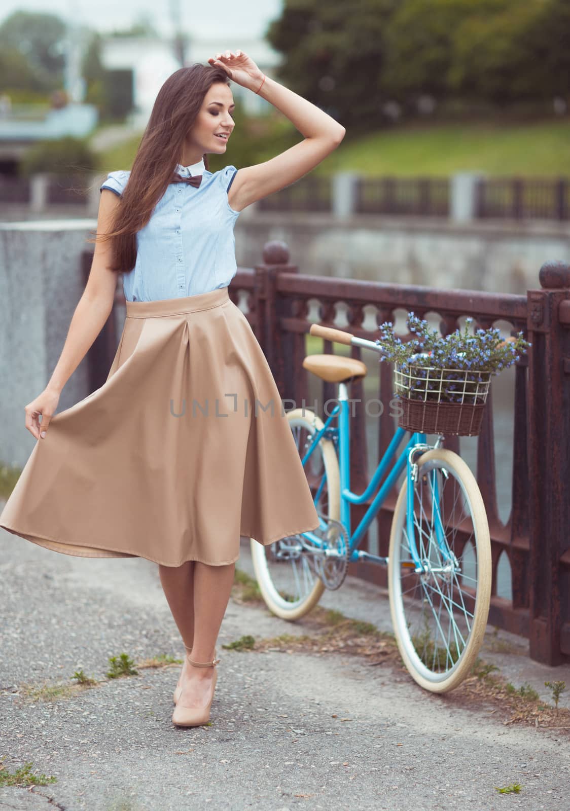 Young beautiful, elegantly dressed woman with bicycle by vlad_star