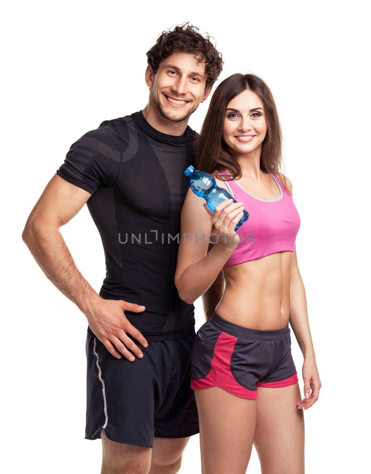 Athletic man and woman with bottle of water on the white background