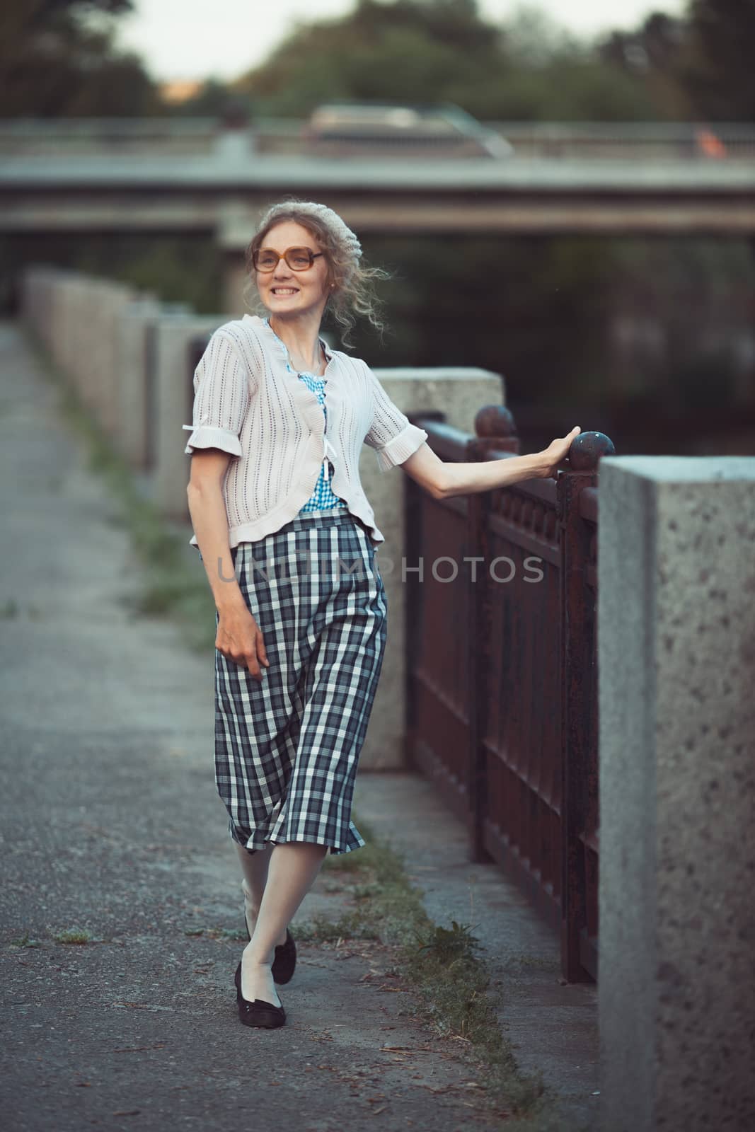 Funny girl with glasses and a vintage dress outdoors