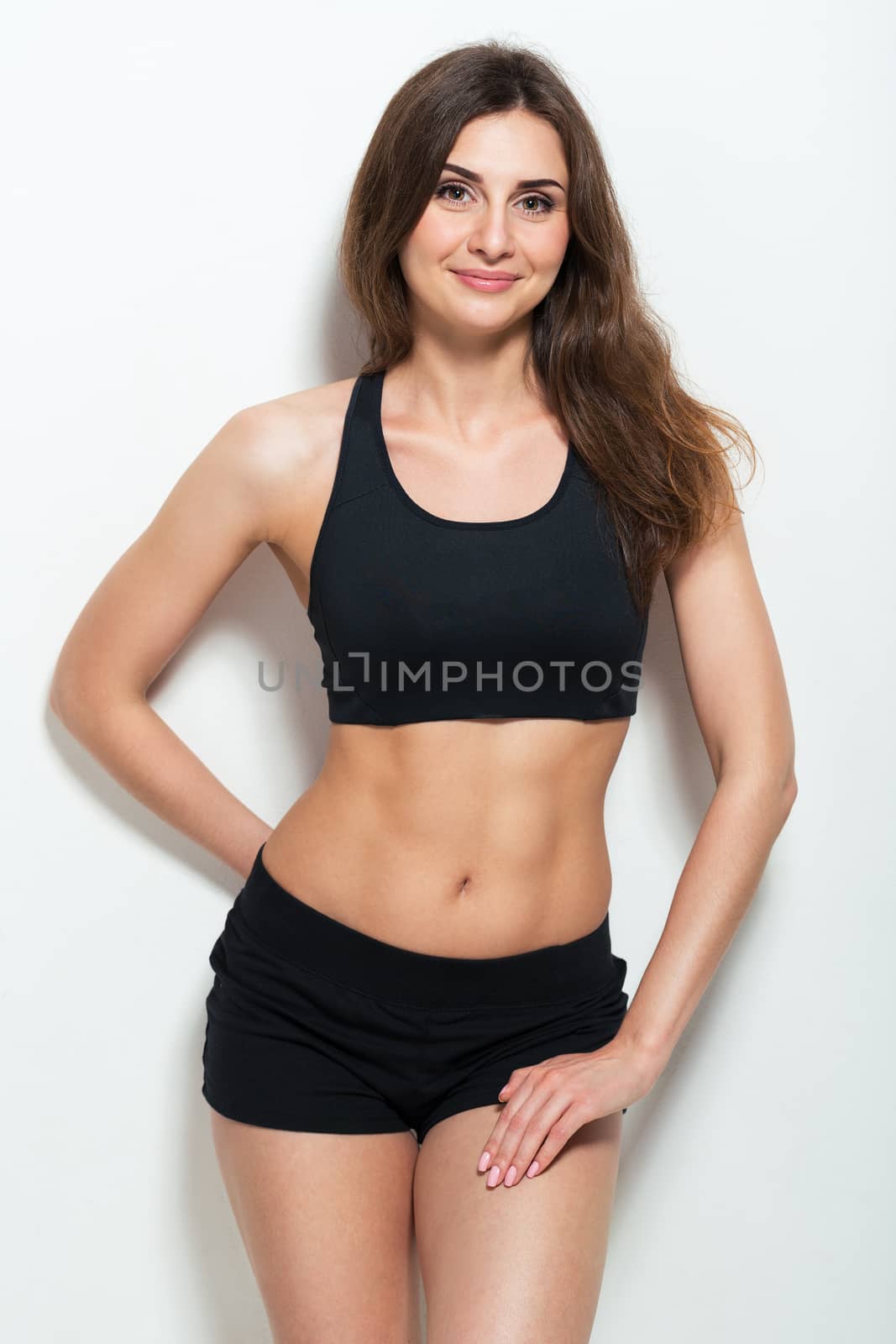 Young athletic girl on white background
