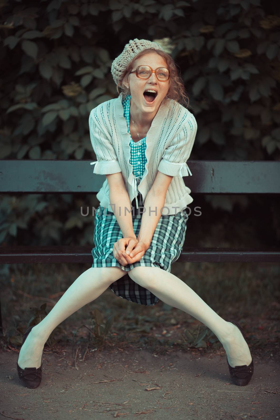 Funny girl with glasses and a vintage dress outdoors