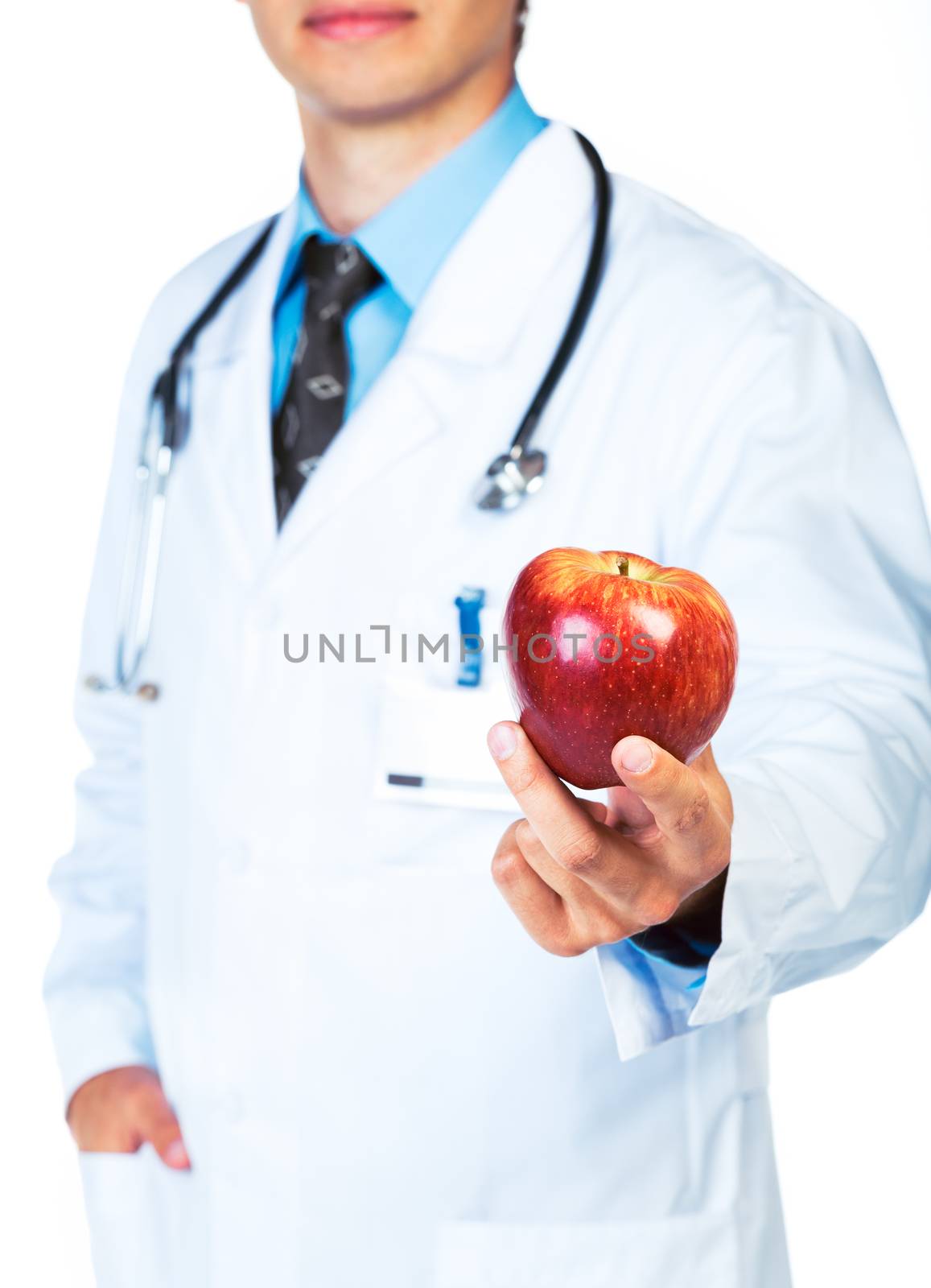 Smiling doctor holding red apple on white close-up