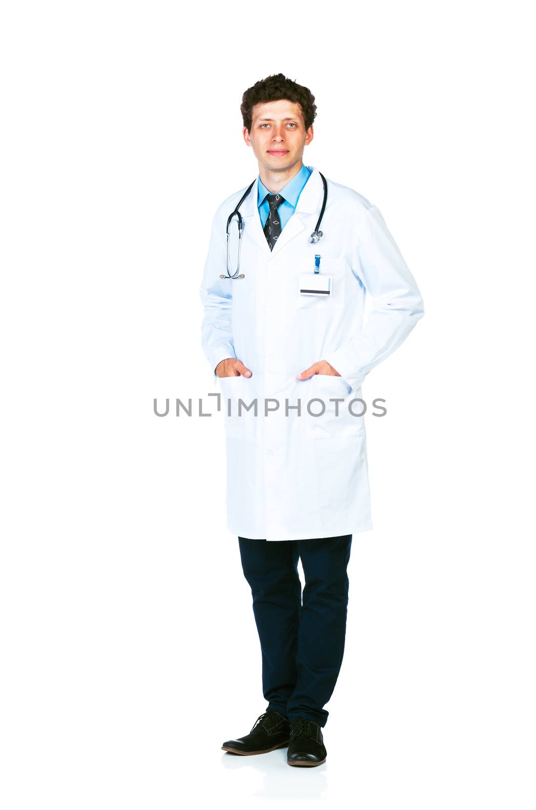 Full length portrait of the smiling doctor standing on a white background