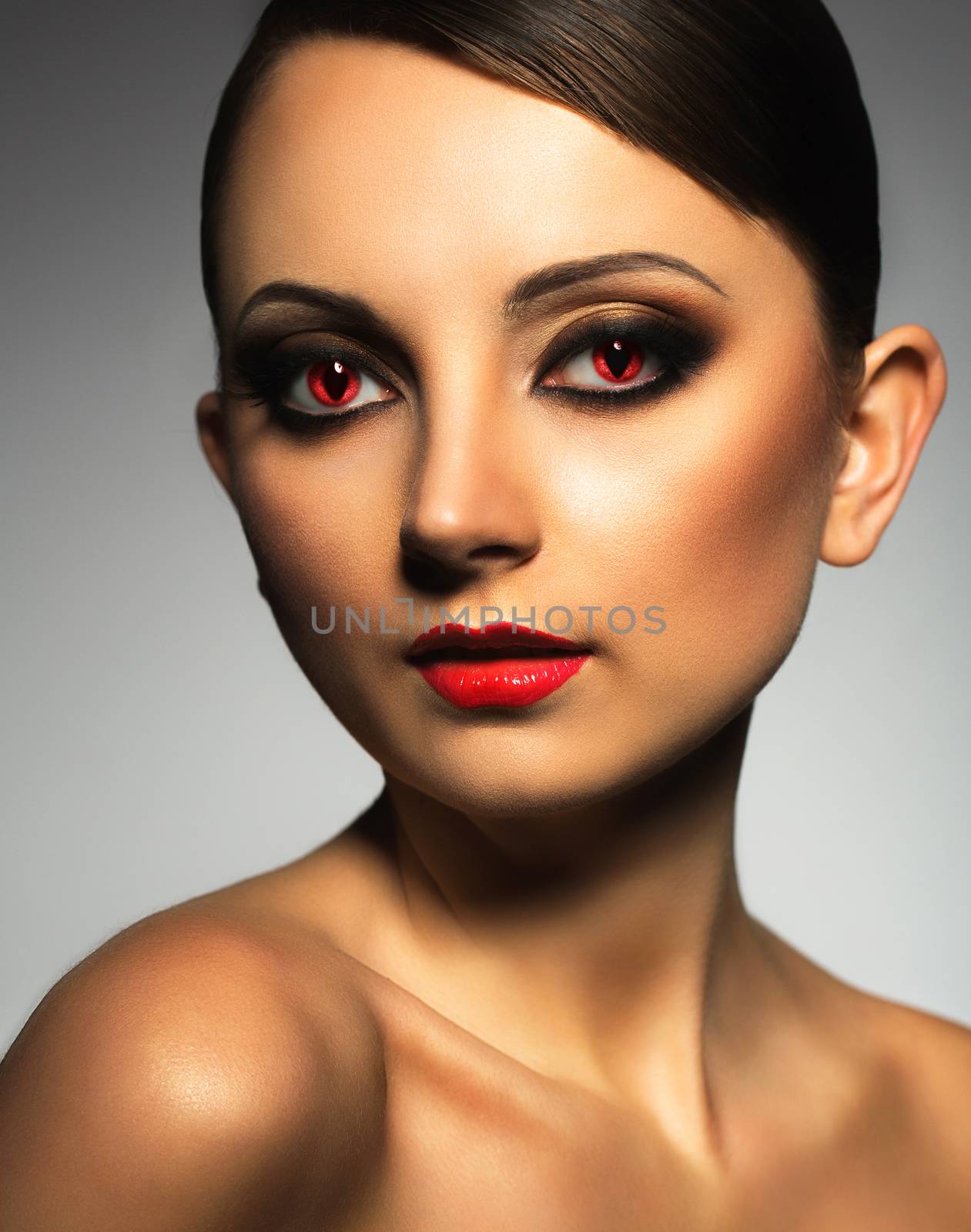 Portrait of a beautiful young woman vampire with a glamorous retro makeup