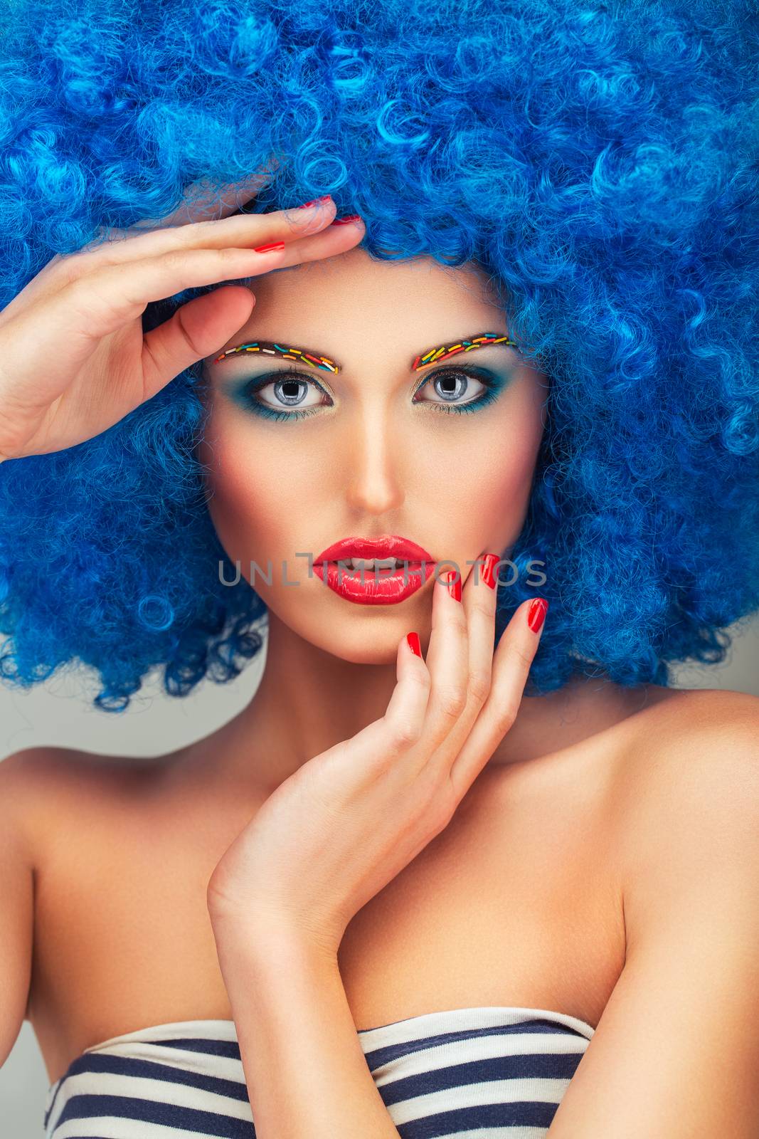 Portrait of a young beautiful girl with bright makeup in blue wi by vlad_star