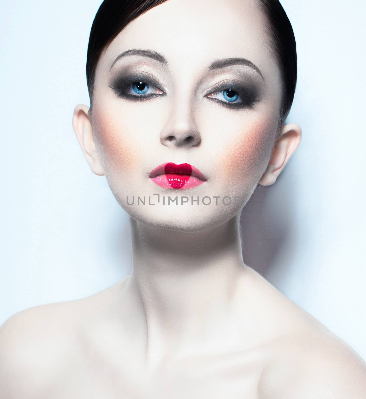 Portrait of a beautiful young woman like doll with a glamorous cool makeup