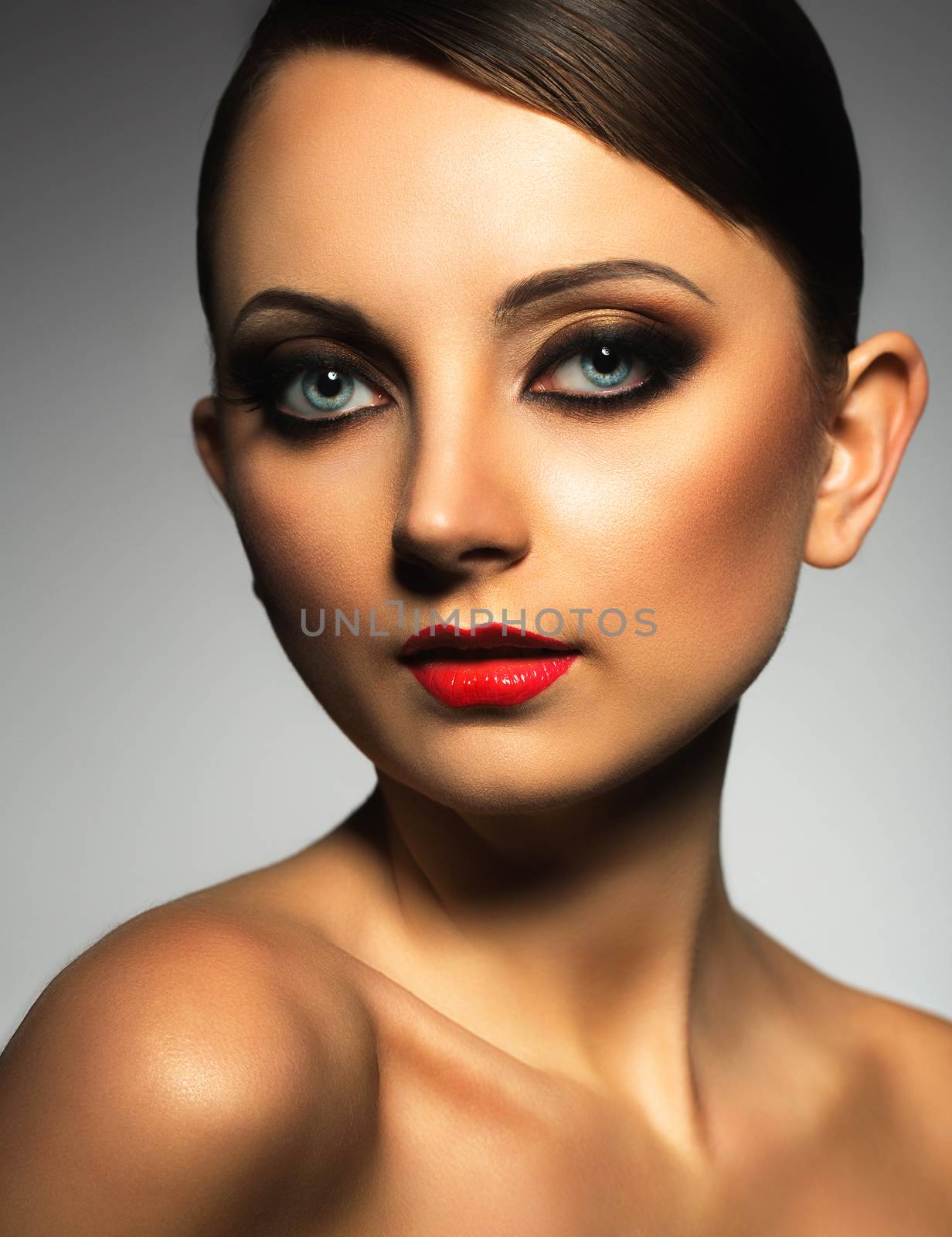 Portrait of a beautiful young woman with a glamorous retro makeup