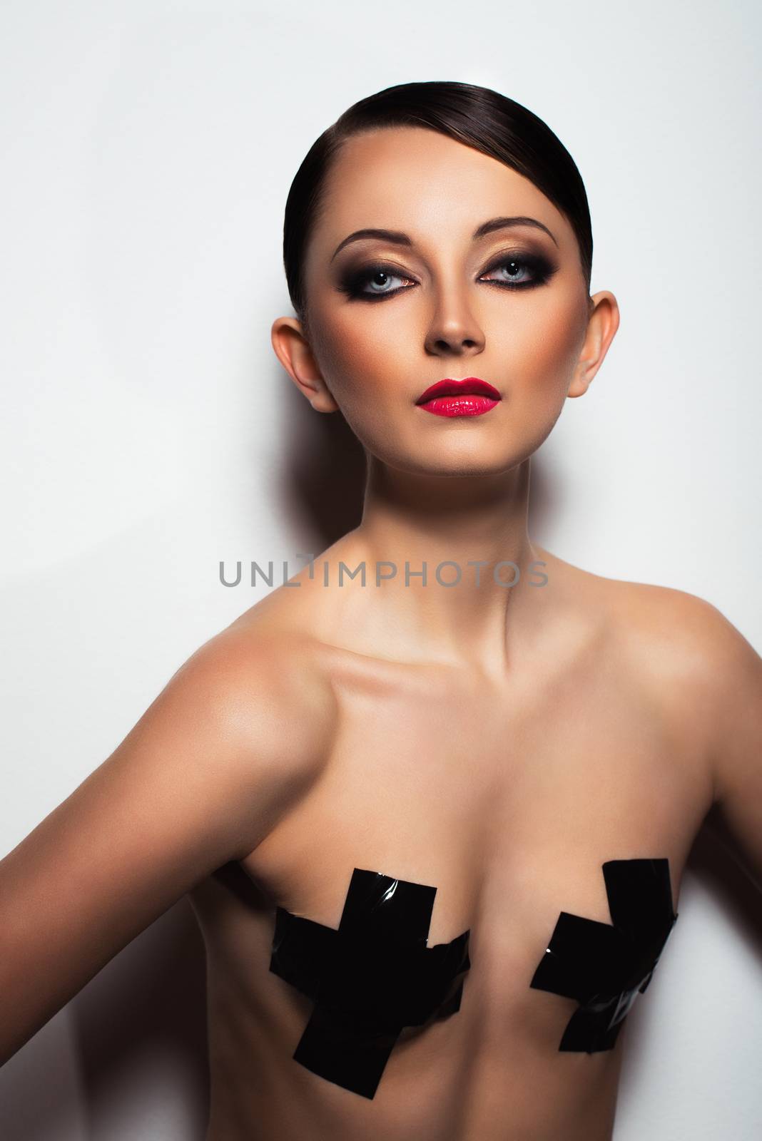 Portrait of a beautiful young woman with a glamorous retro makeup