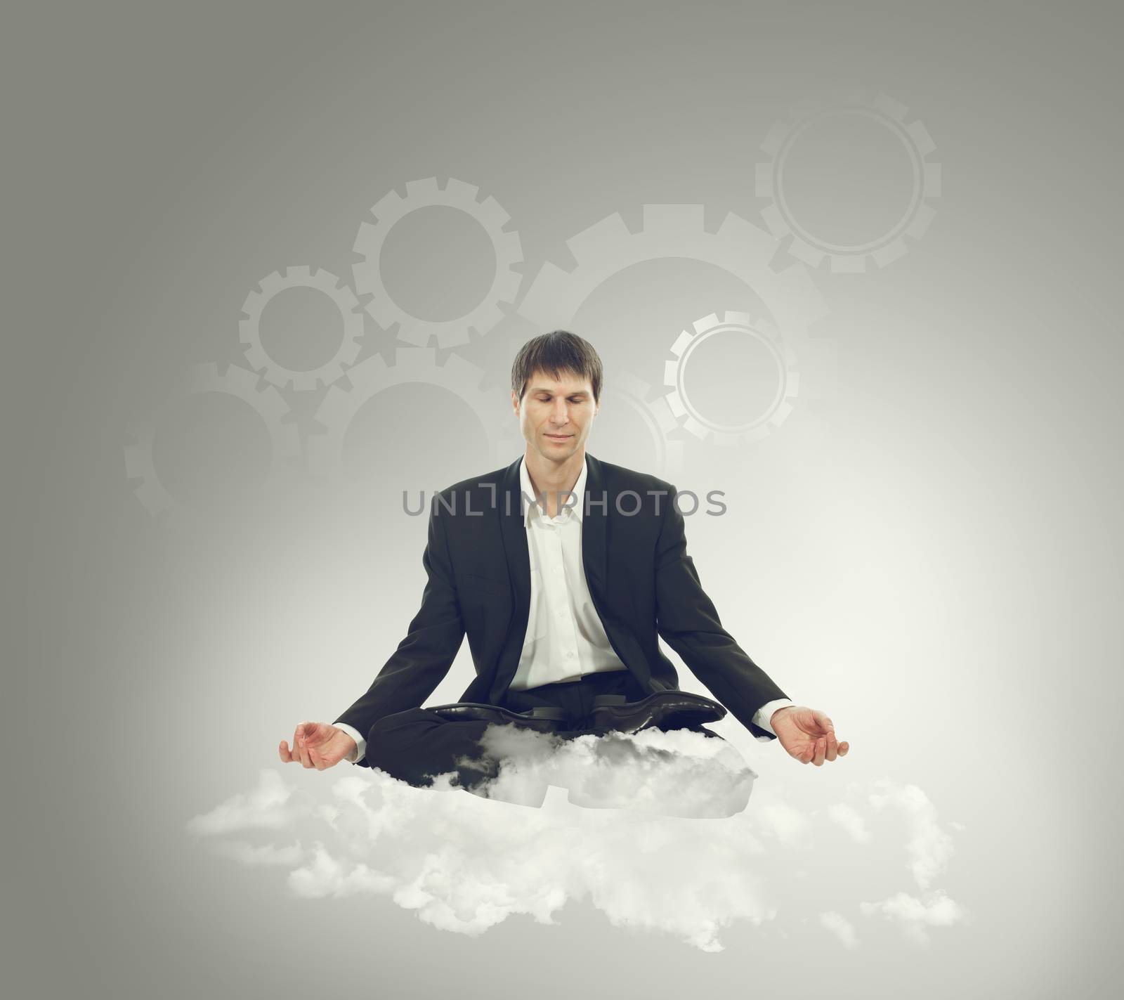 Businessman sitting in lotus position on a cloud and think mechanical thoughts