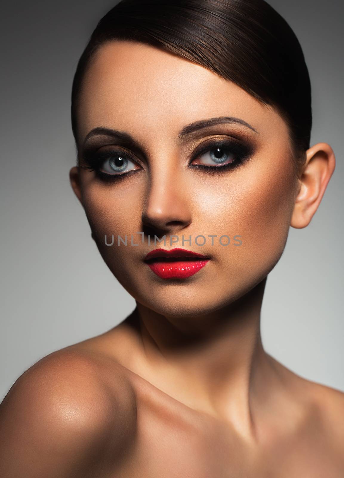 Portrait of a beautiful young woman with a glamorous retro makeup