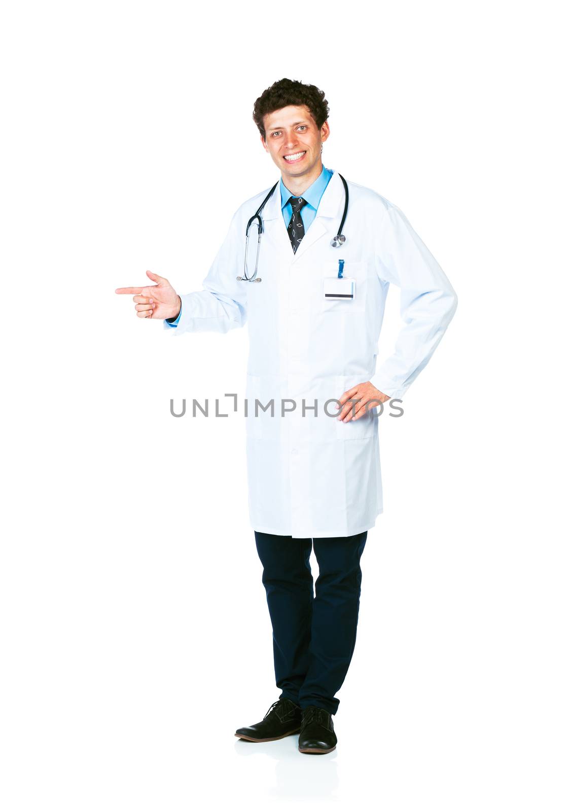 Portrait of a smiling young male doctor pointing sideways on white background