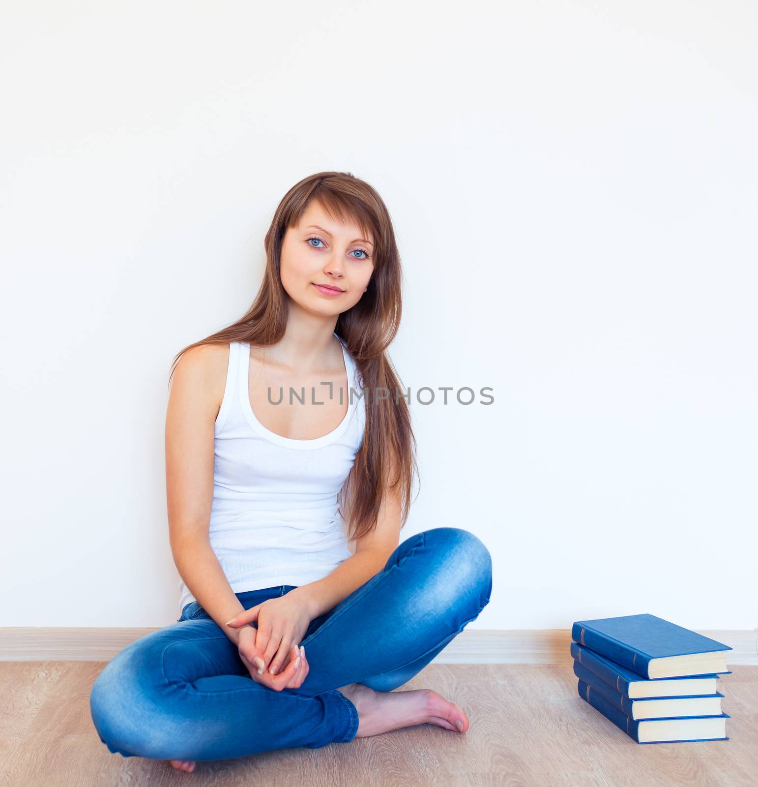 Young caucasian brunette and a books at home